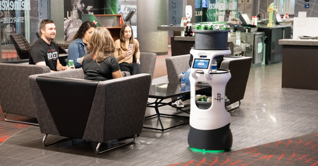 A Servi service robot handing food and snacks in the hotel lobby.