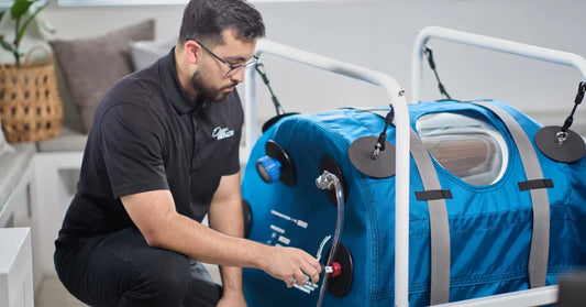 Image of a person setting up a hyperbaric oxygen chamber.