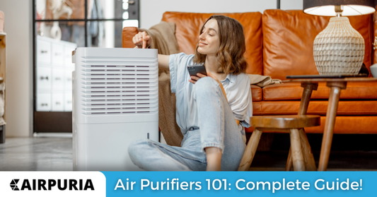 An image of a woman with a clean space with an air purifier next to her containing a HEPA filter and relating to the importance of our air purifier buying guide for 2023.